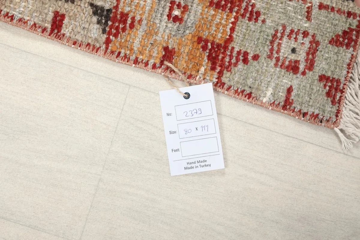 Close-up of the rug's corner with the product tag showing size and origin