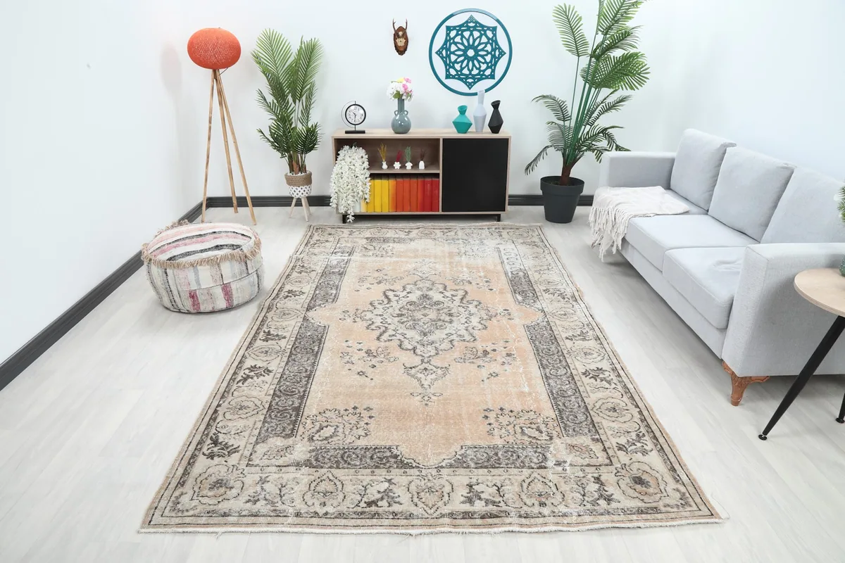 Large area rug with beige field and charcoal patterns in a modern living room setting