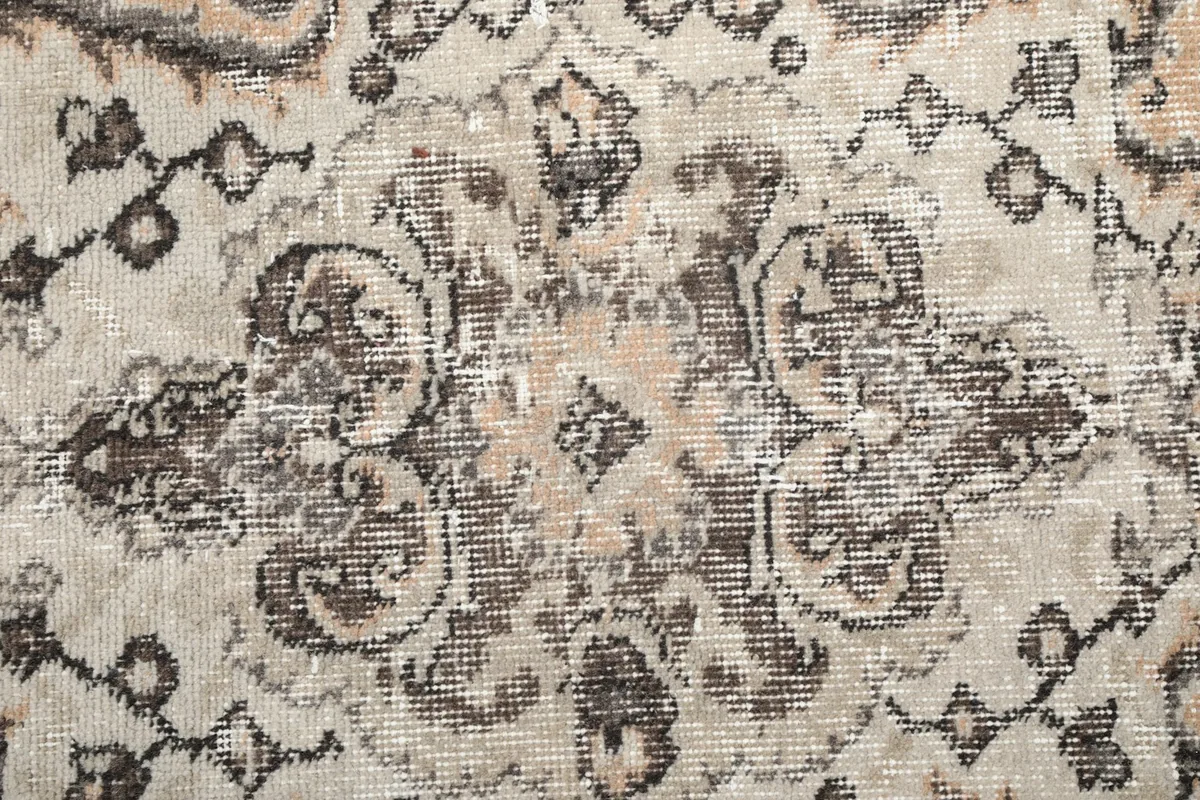 Detailed view of the wool pile and intricate knotting, showing color variations