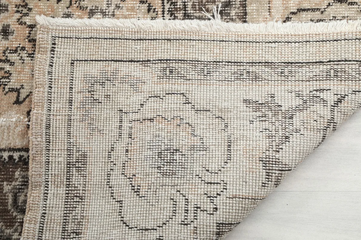 Close-up of the rug's reverse, revealing the hand-knotted construction and fringe