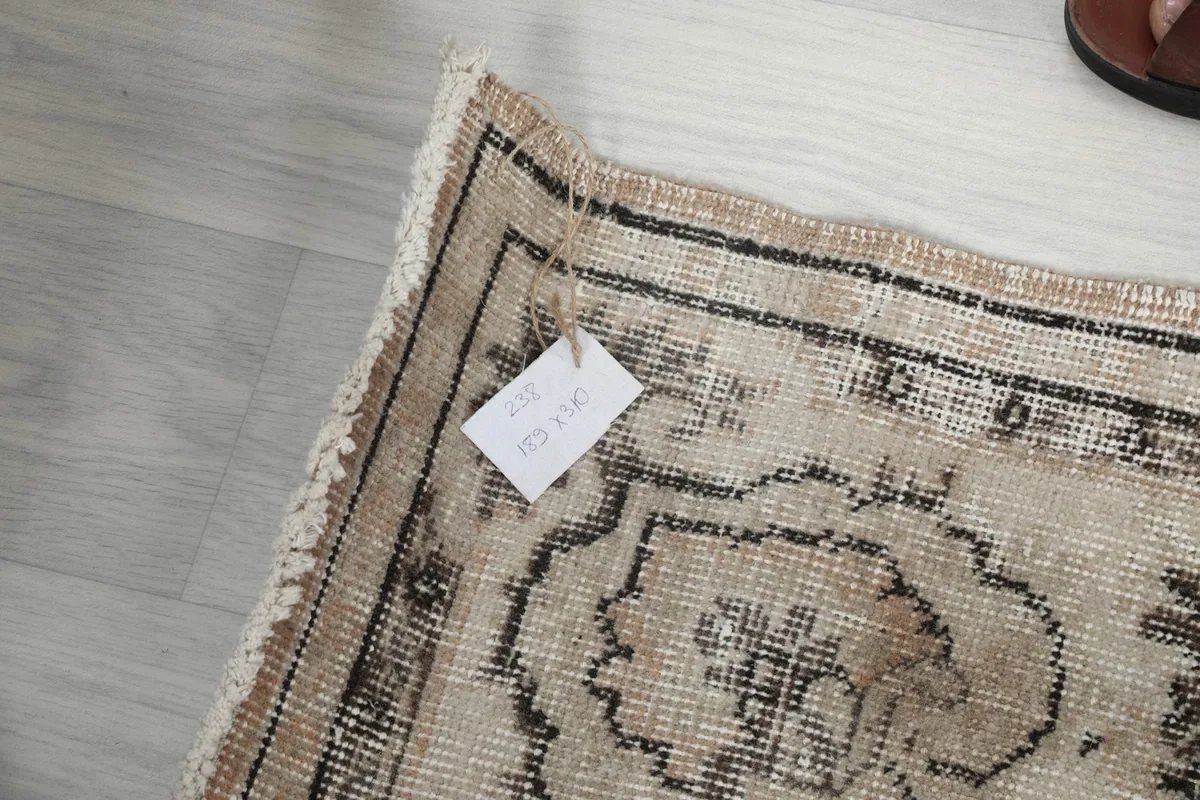 Corner of the rug with a tag displaying product information