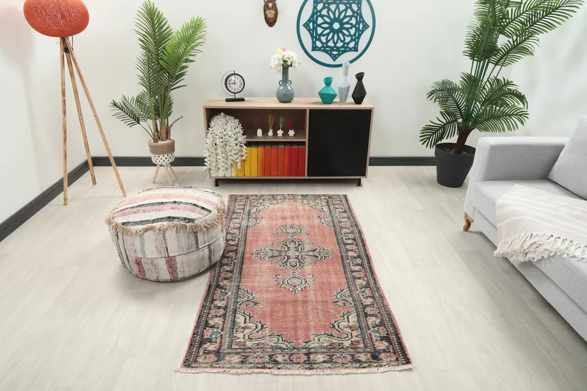 Anatolian rug in a modern living room setting with light furniture and plants