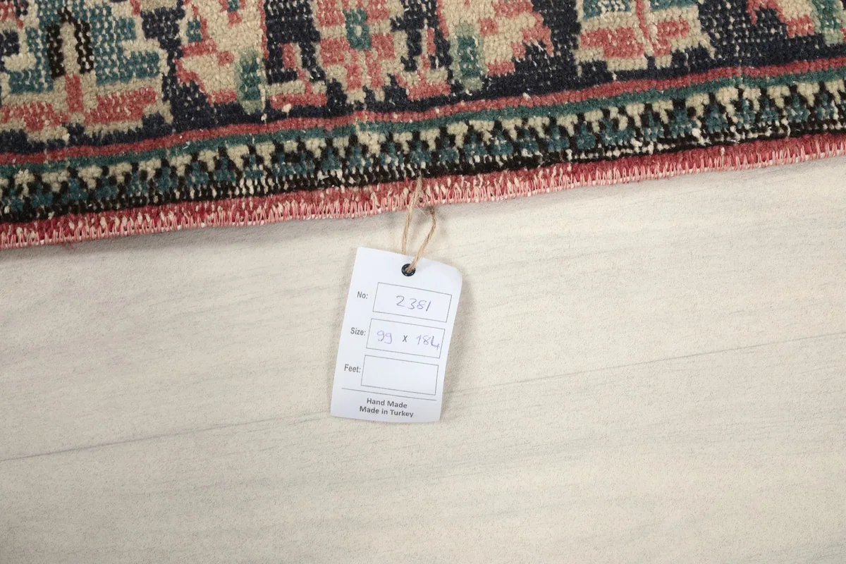 Close-up of the rug's tag, indicating its dimensions and origin