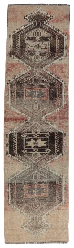 Full overhead view of the beige and rust vintage Anatolian runner rug with black geometric patterns.