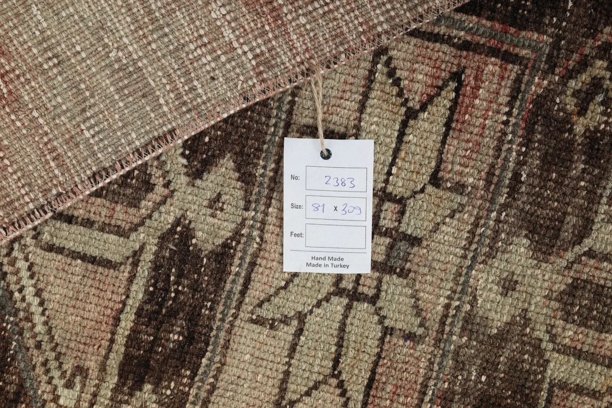 Close-up of the rug's texture with a product tag showing size and origin details.