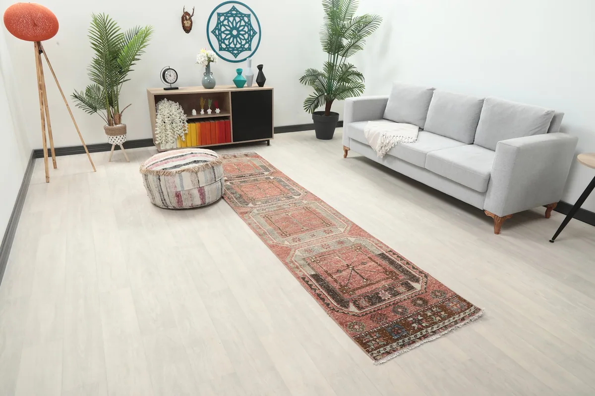 Angled view of the rust geometric runner rug in a room, highlighting its placement and pattern.