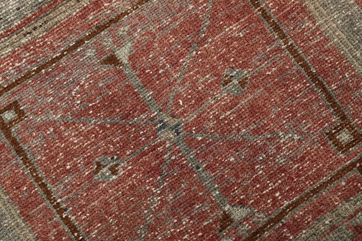 Texture and low pile of the rust wool runner rug, showing color variations and hand-knotted detail.