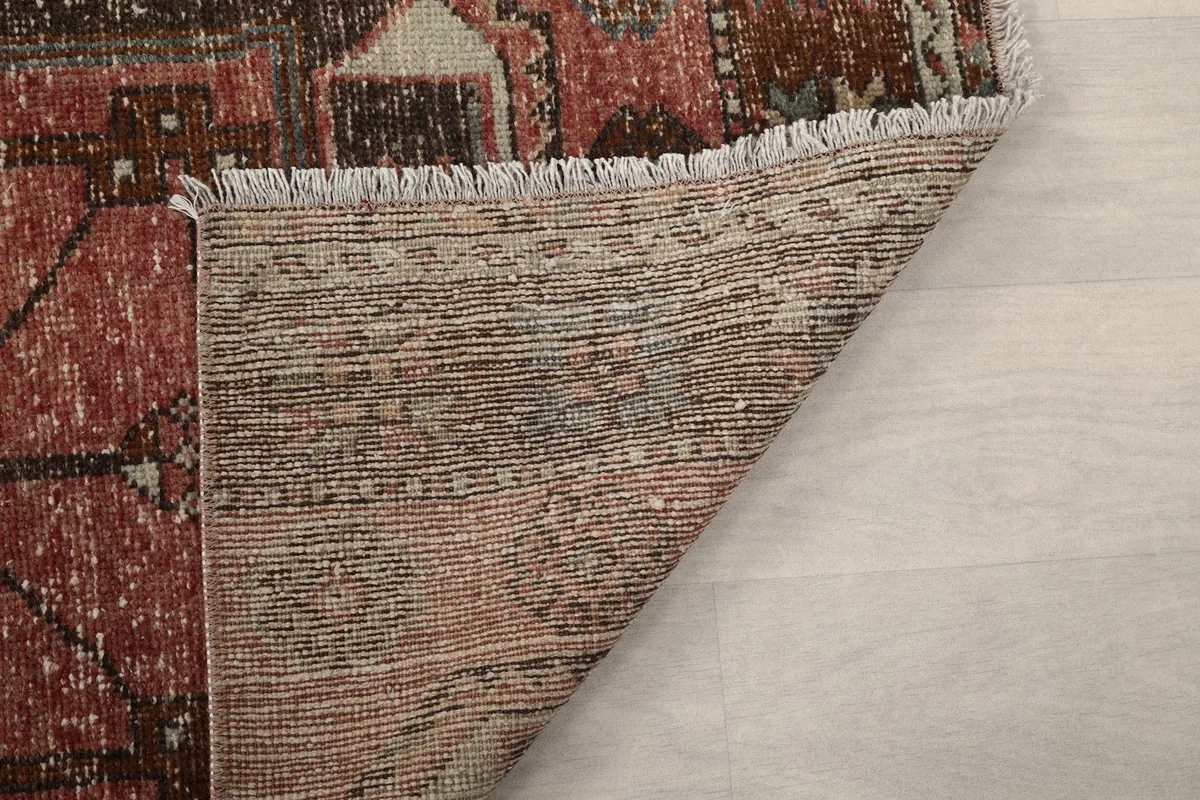 Detailed view of the back of the runner rug, showing the weave and construction.
