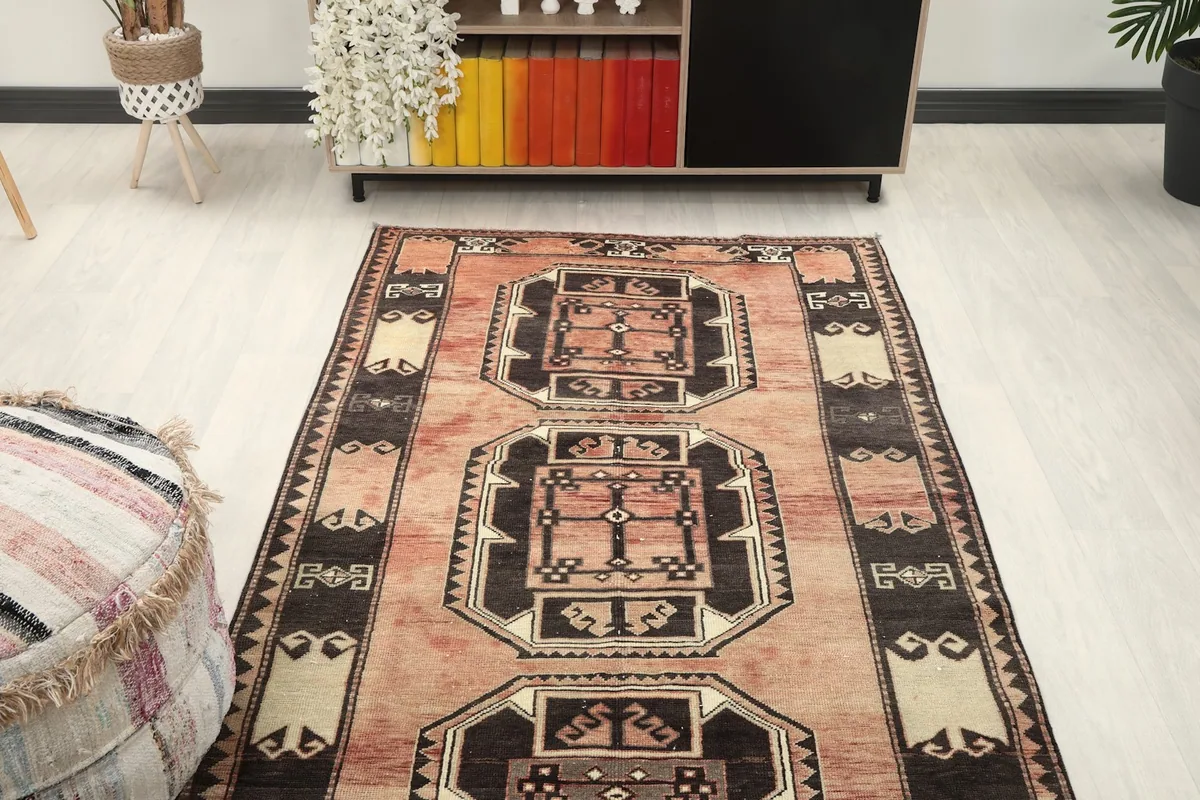 Overhead view of the rose geometric runner laid out in a room, showing its full pattern