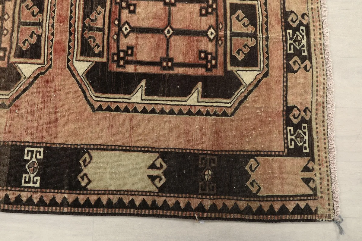 Detailed view of the runner's end, showing the border design and part of the main geometric motif