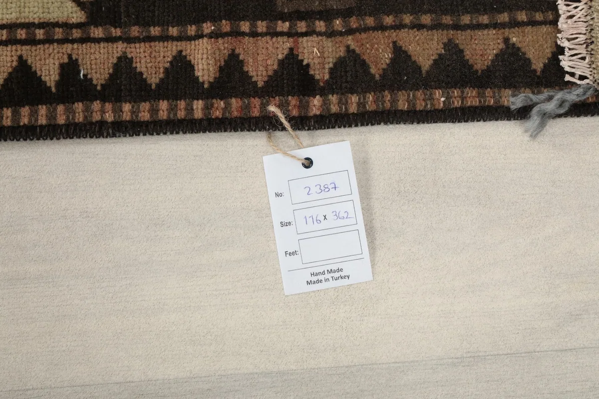 Close-up of the rug's back with a tag indicating its dimensions and origin from Turkey