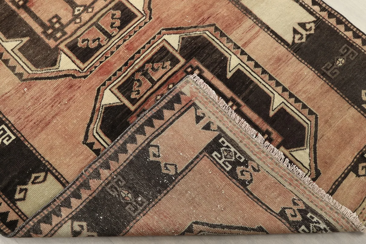 Folded corner of the runner, showing the thickness of the wool pile and cotton foundation