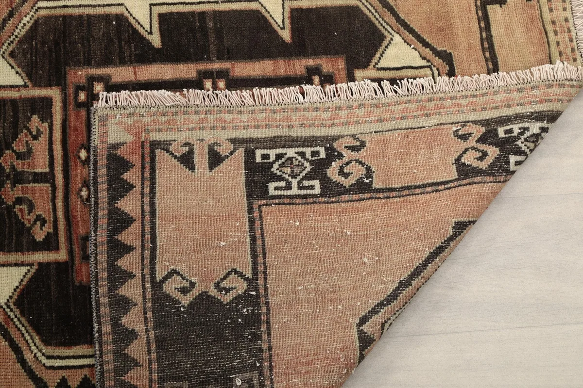 Another folded corner, revealing the hand-knotted construction and fringe detail