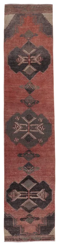 Full overhead view of the rust and charcoal geometric Anatolian runner on a white background.