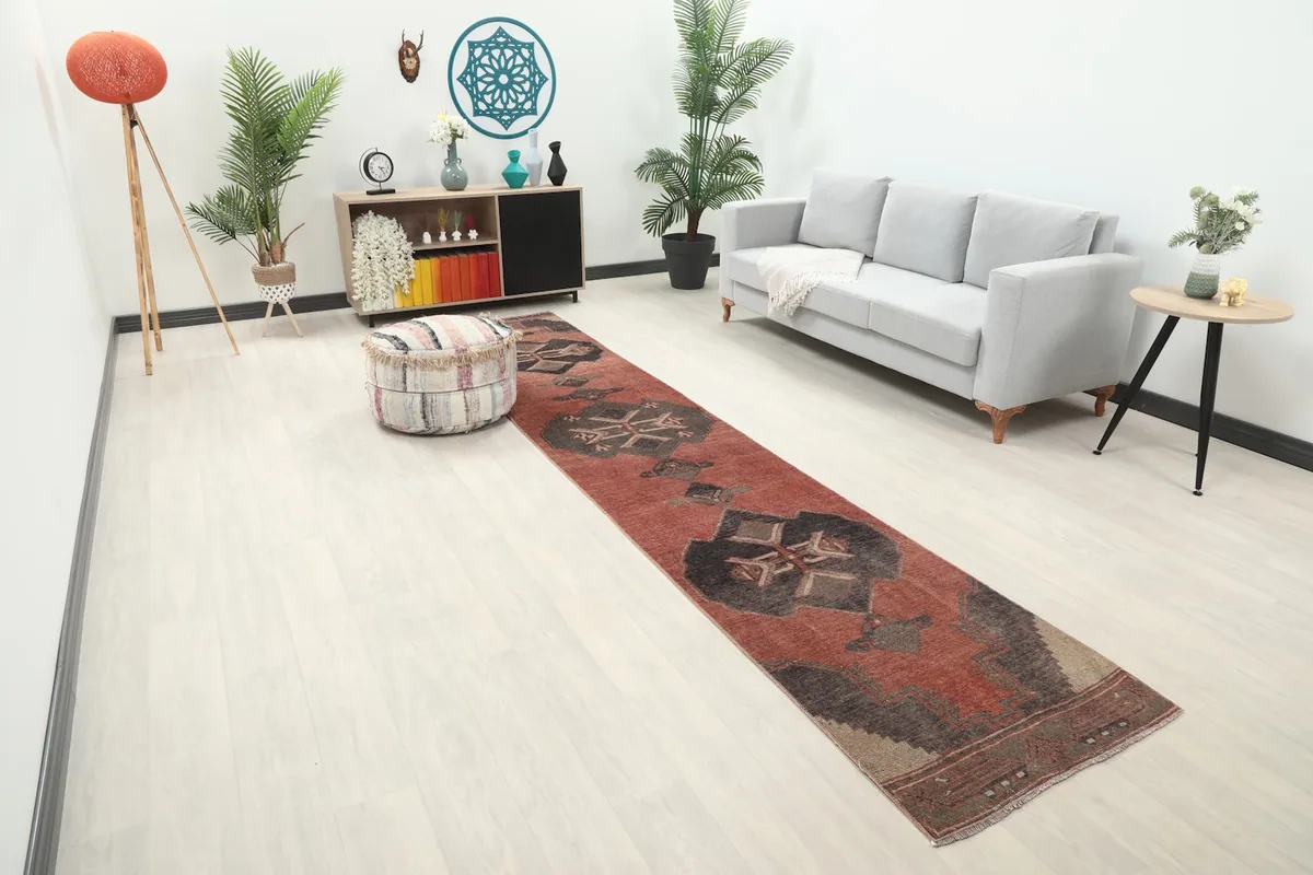 Anatolian runner extending down a hallway, showcasing its length and geometric design in a home setting.