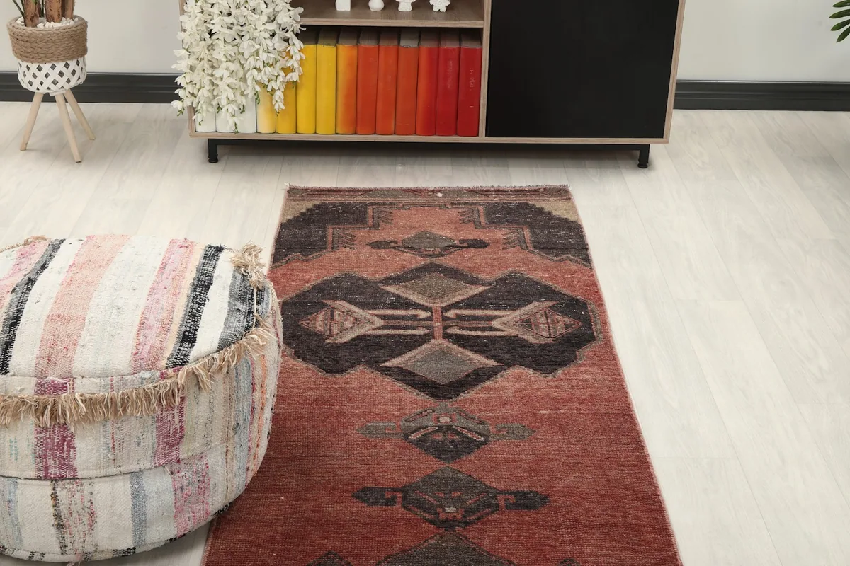 Runner rug in a hallway setting, showing the rug's middle section and surrounding decor.