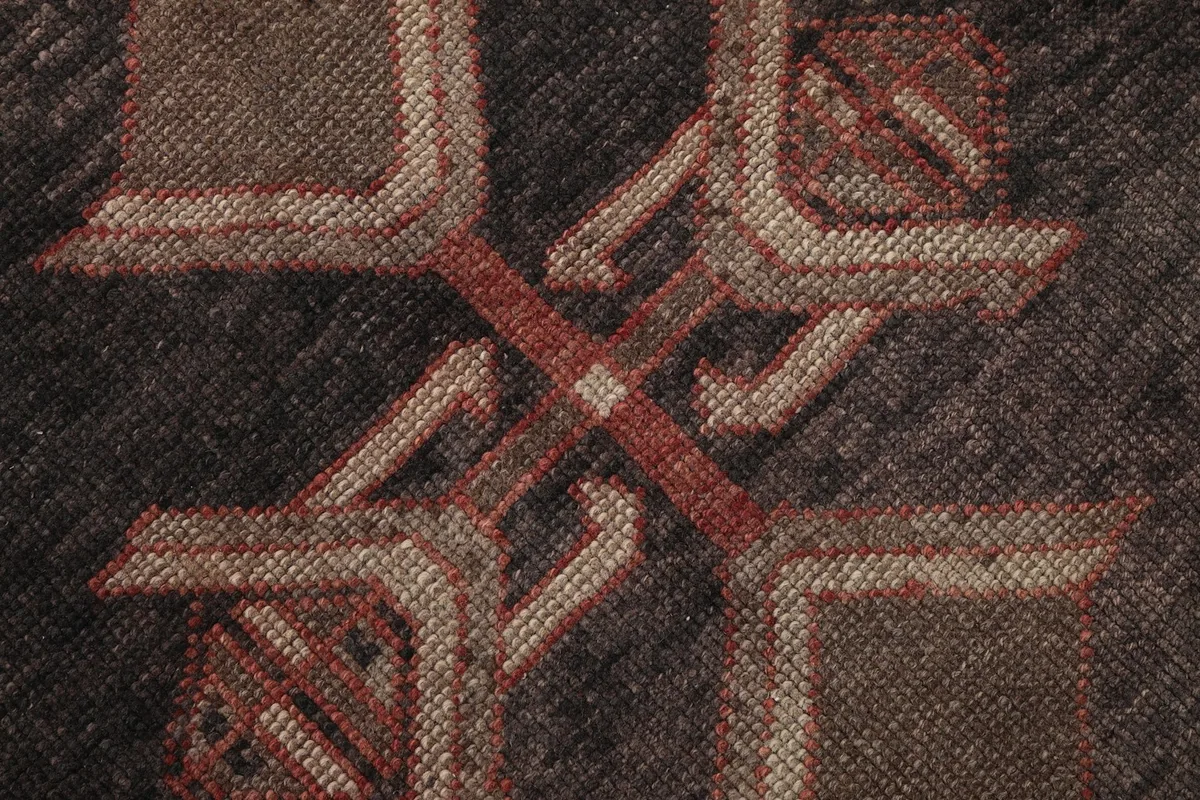 Very close view of the hand-knotted wool pile, revealing the texture and subtle color variations within a motif.