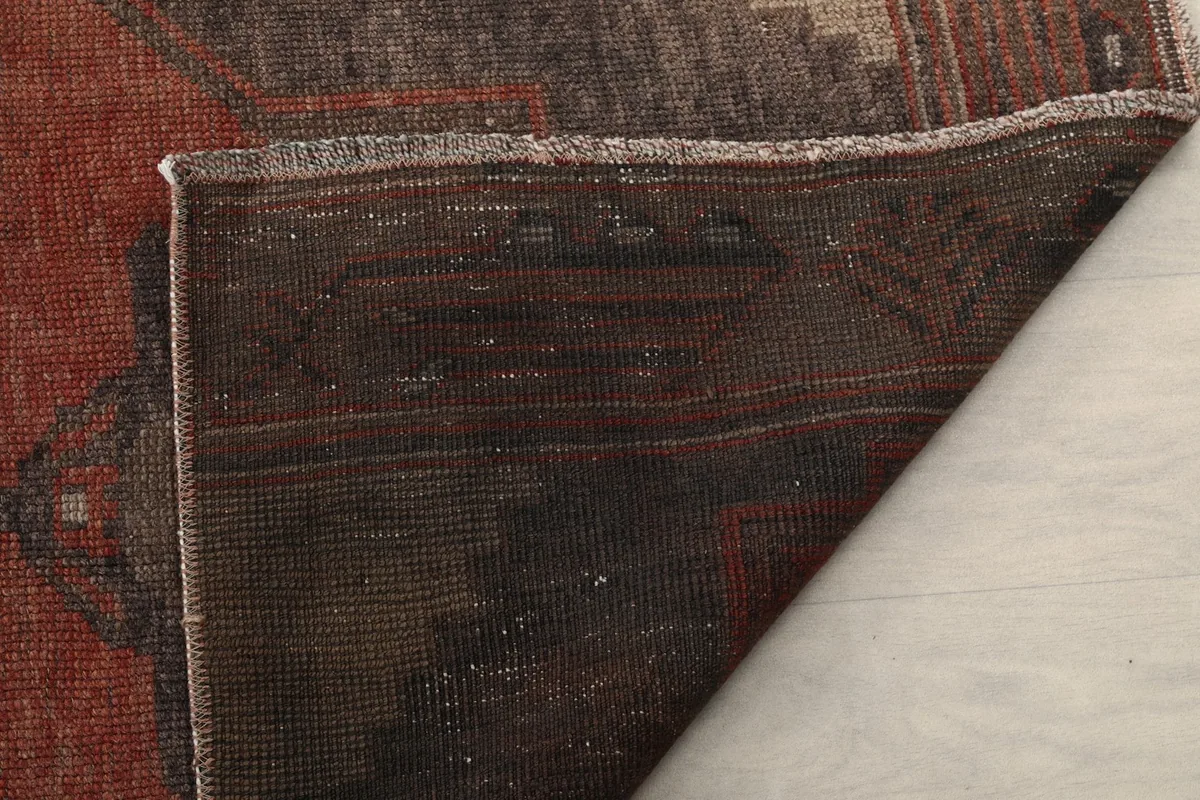 Detailed view of the rug's back, revealing the tight hand-knotted construction and foundation.