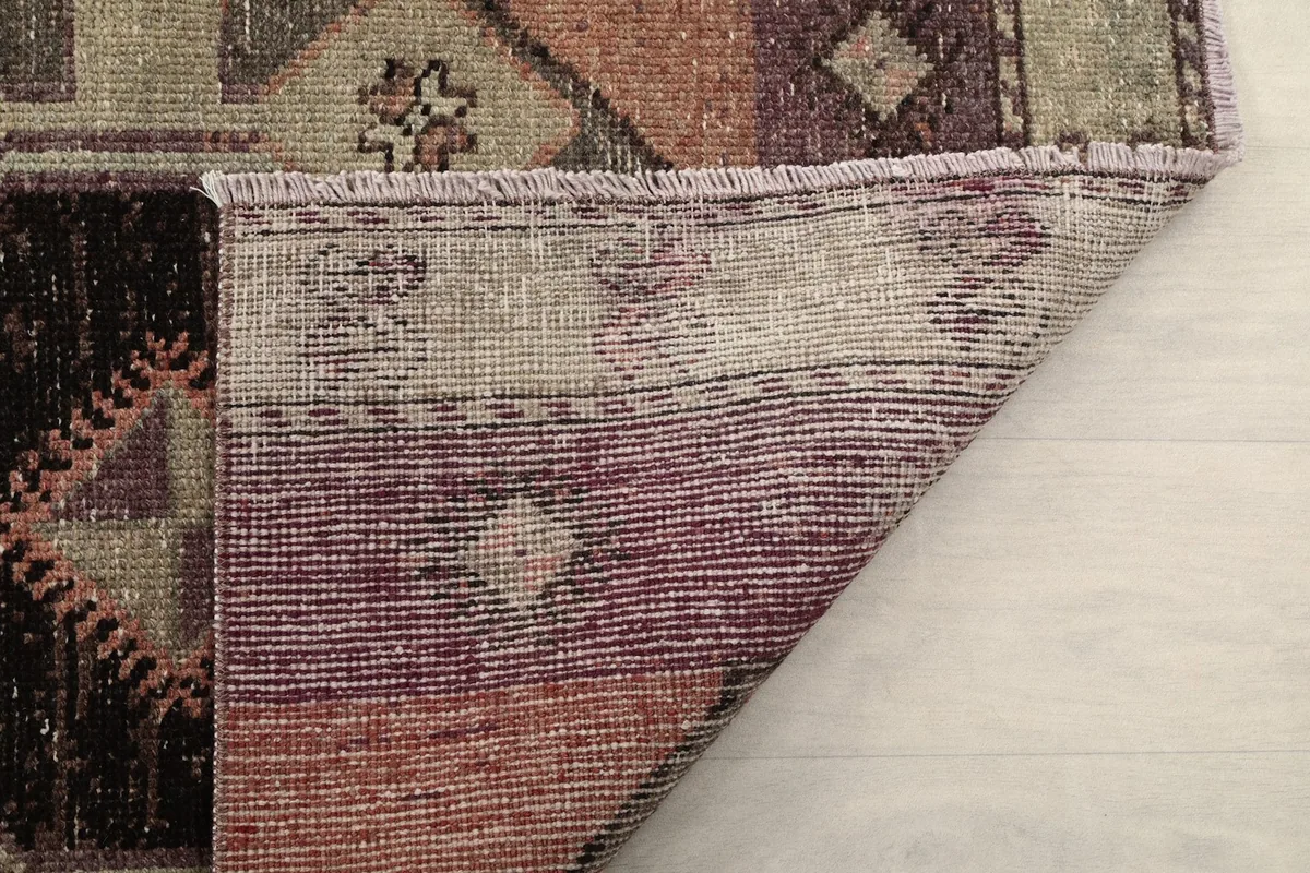 Underside of the rug showing the tight weave of the cotton foundation and wool knots