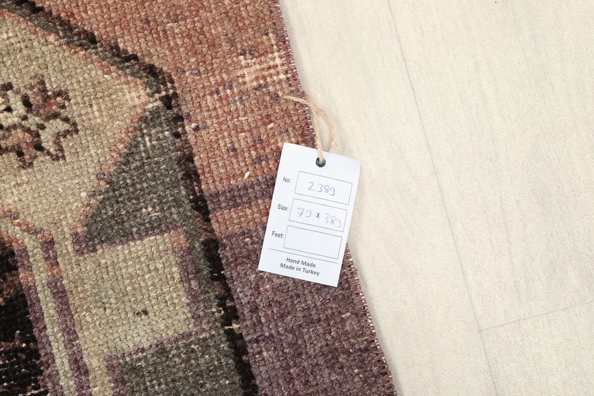 Close-up of the product tag attached to the rug, showing details like item number and origin