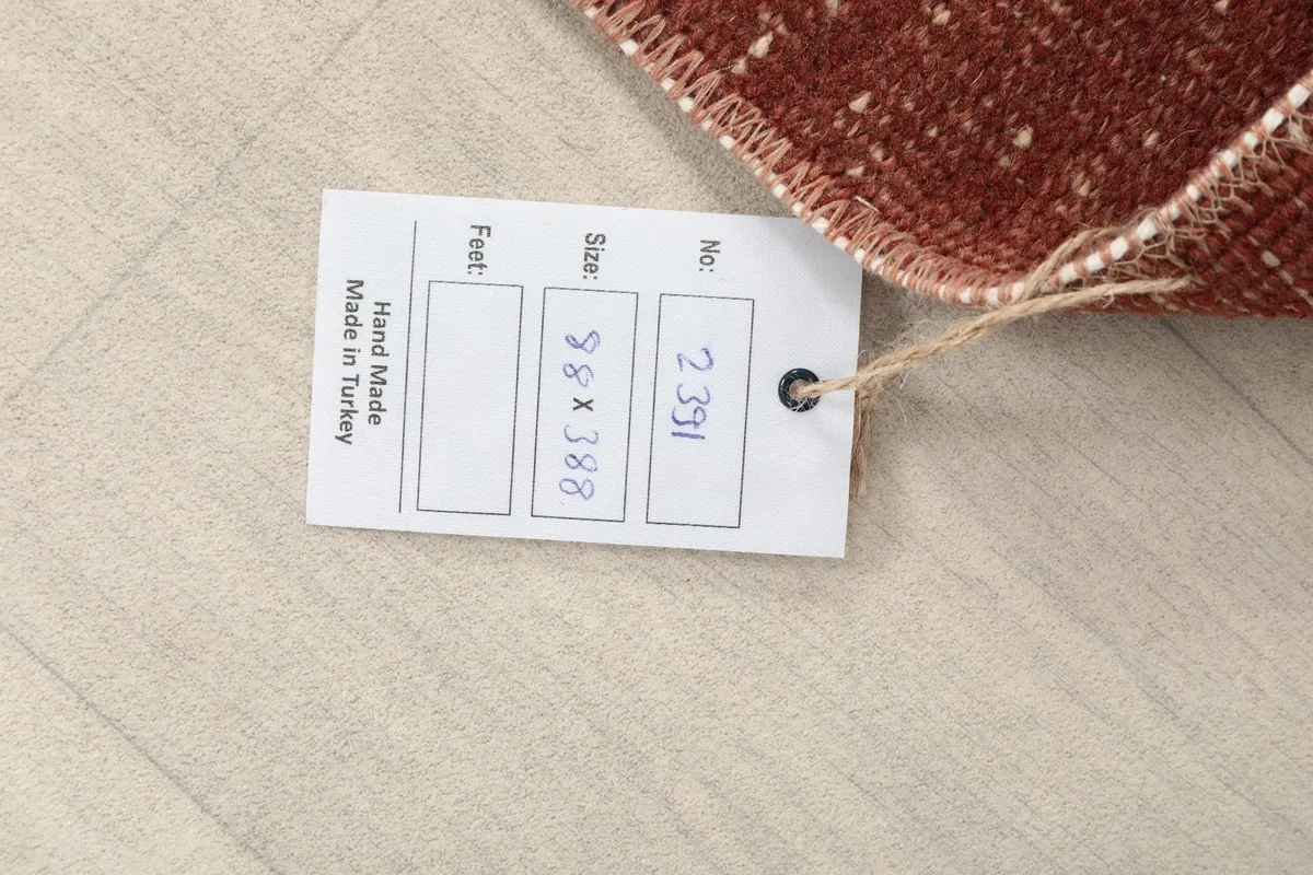 Product tag showing the rug's dimensions in centimeters (88 x 388 cm) and its origin