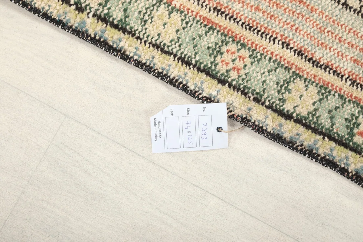 Close-up of the rug's edge and label, indicating its origin and material
