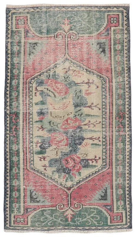 Top view of the rose and green vintage Anatolian rug with floral medallion.