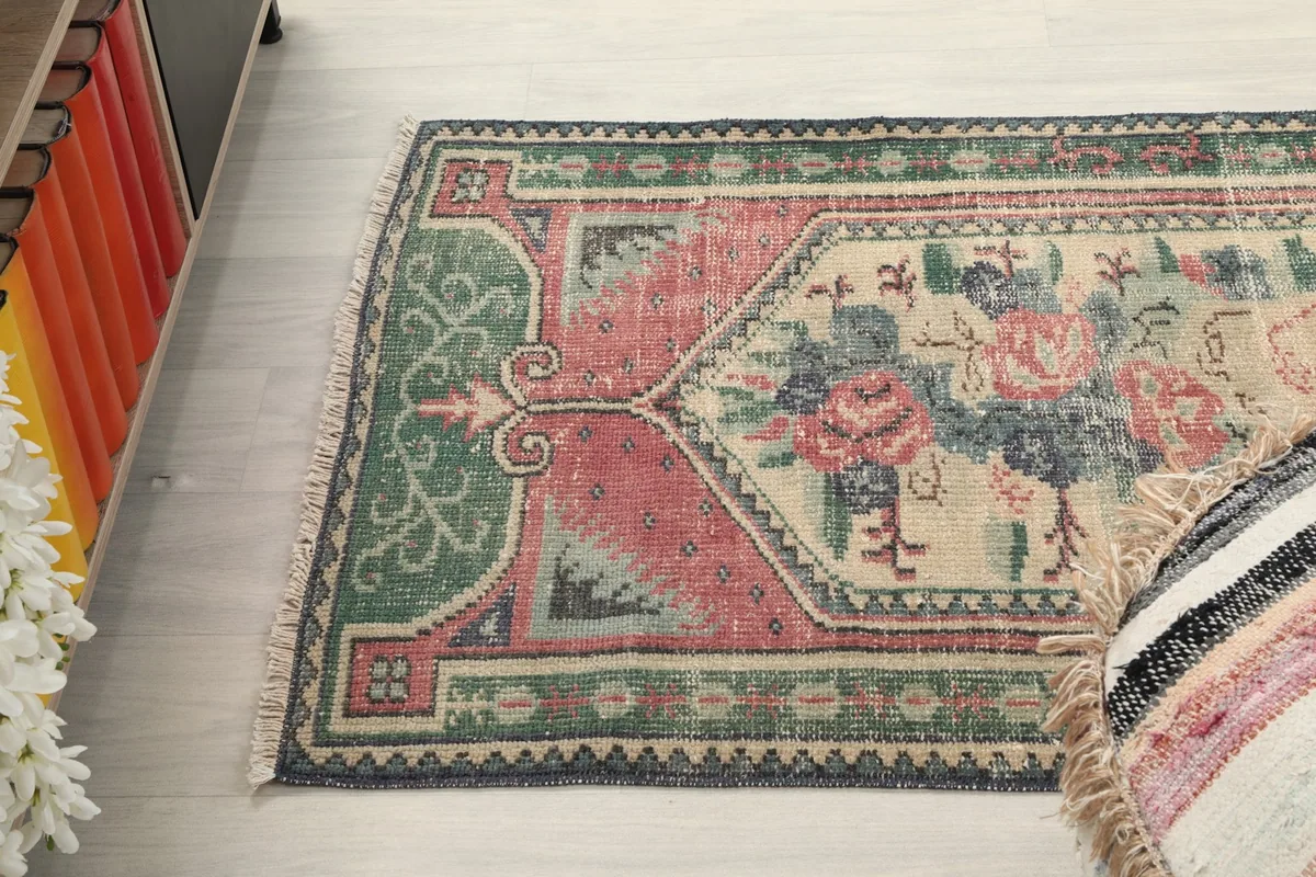Angle view of the rug's length, showing the border design and central motif.