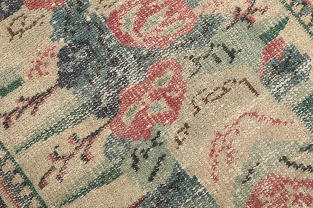Close-up of the low wool pile, showing the texture and colors of the hand-knotted rug.