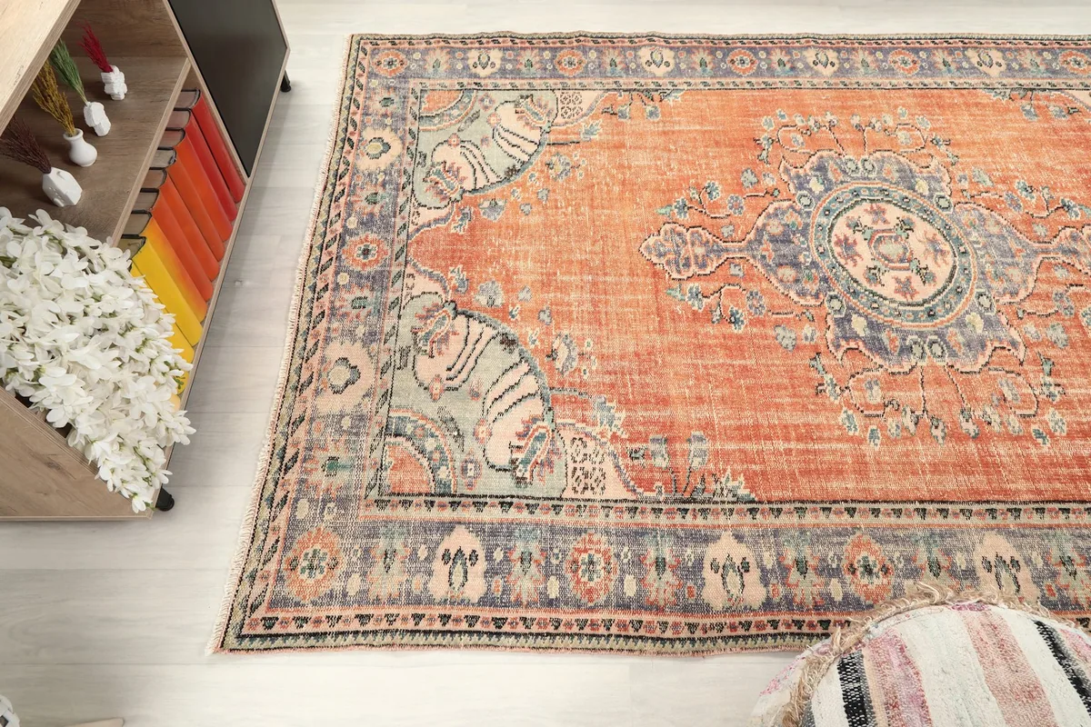 Wide angle view showing the rug's placement and the distressed texture
