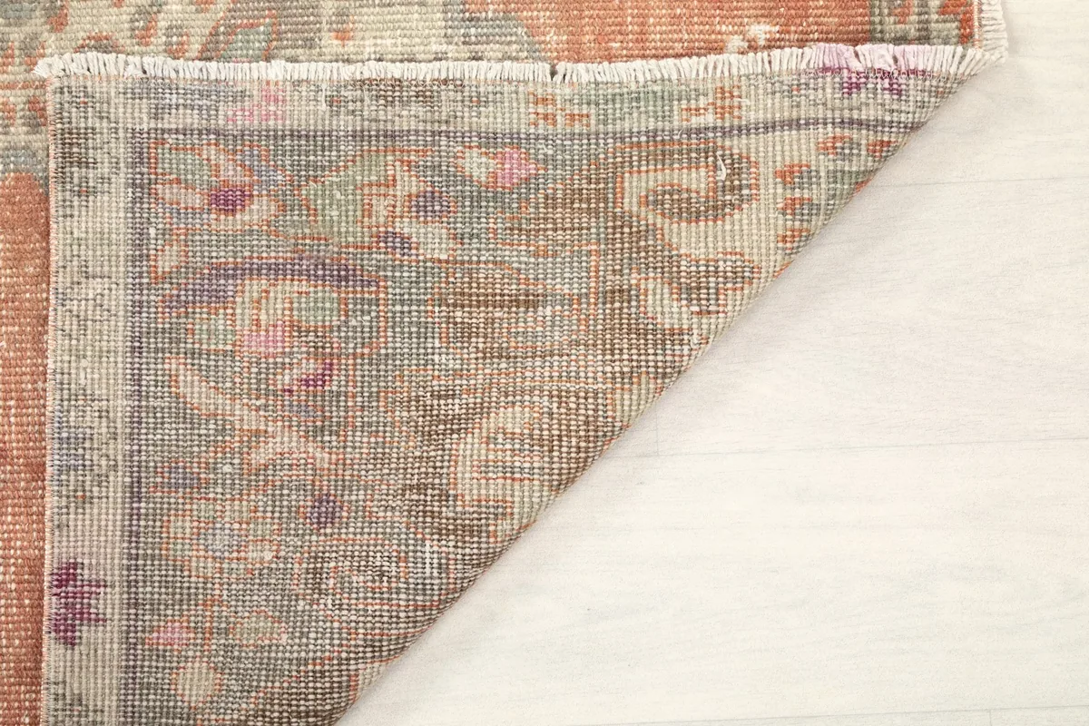 Backside of the rug showing the hand-knotted construction and fringe