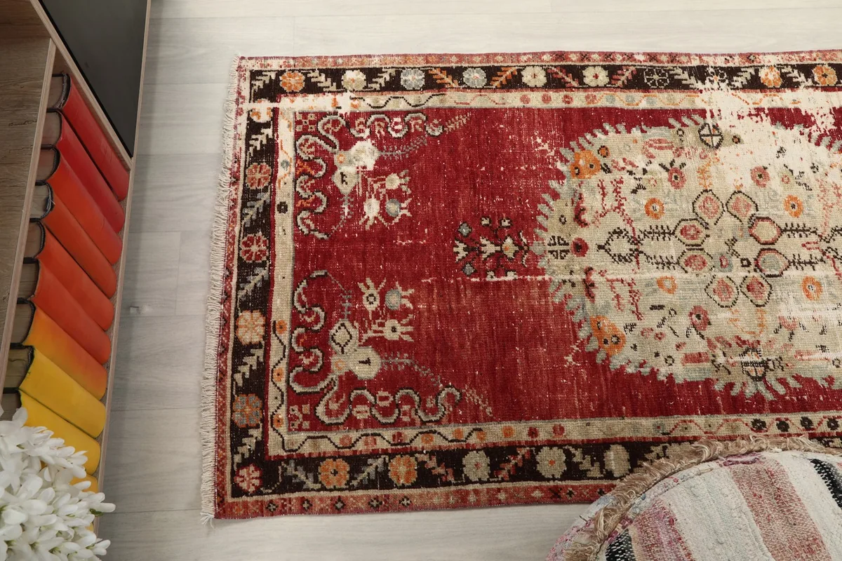 Overhead view of the rug's full length, emphasizing the distressed areas and color variation