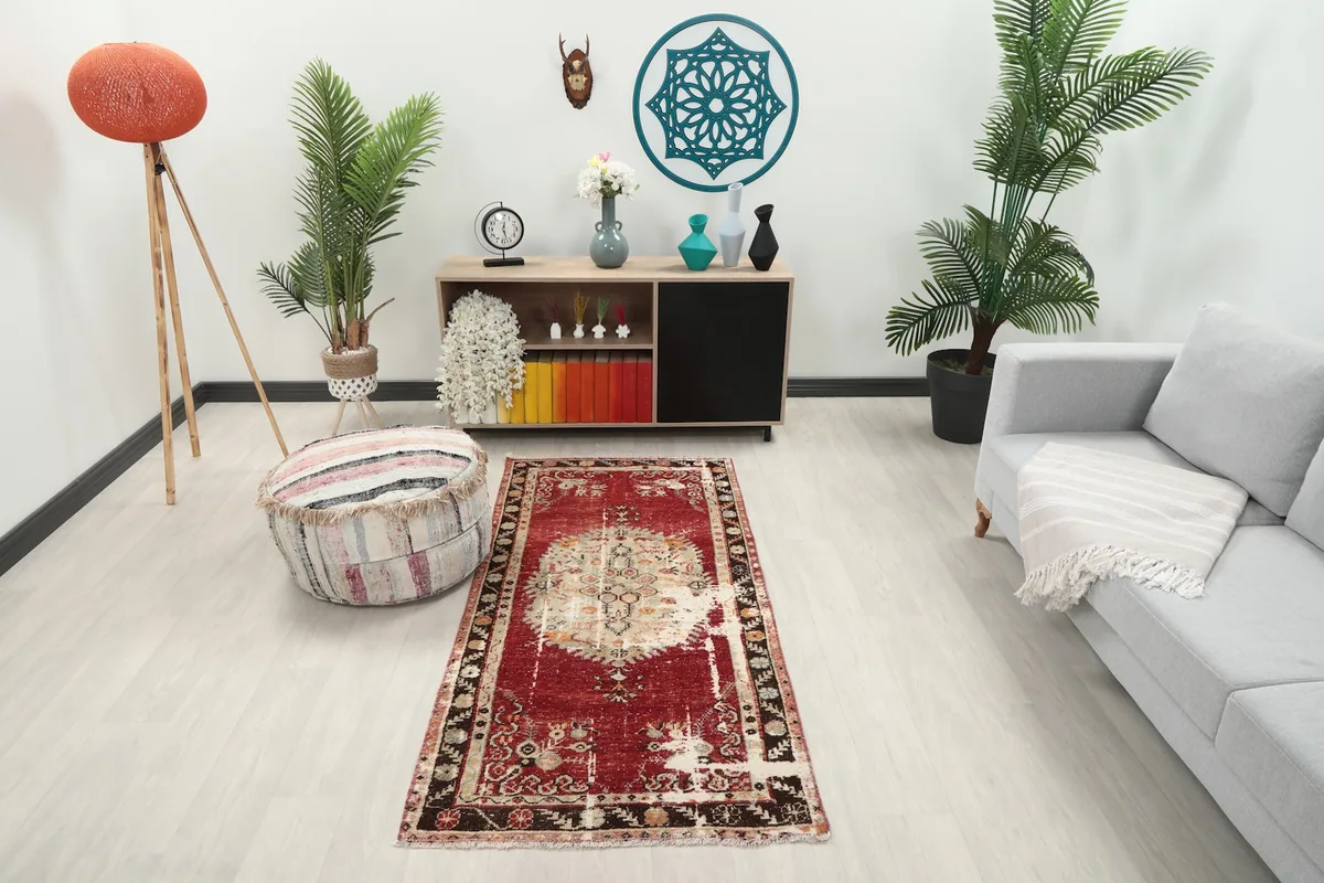 Vintage red Anatolian runner in a modern living room setting with a gray sofa and light wood floor