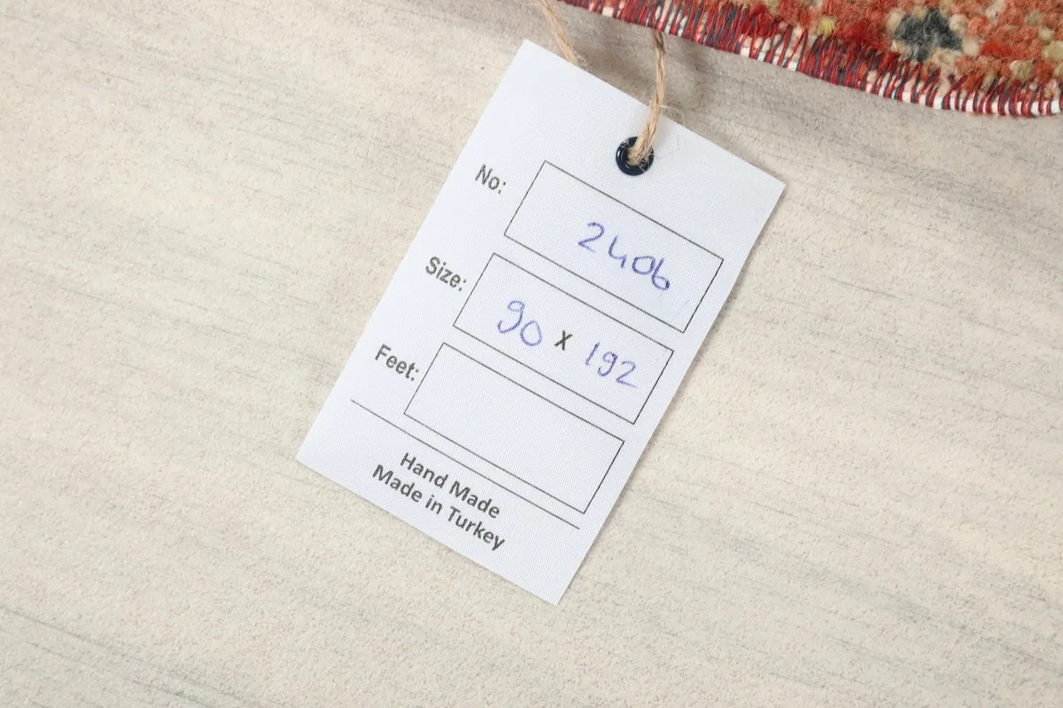 Product tag displaying the rug's number and size in centimeters, indicating handmade in Turkey