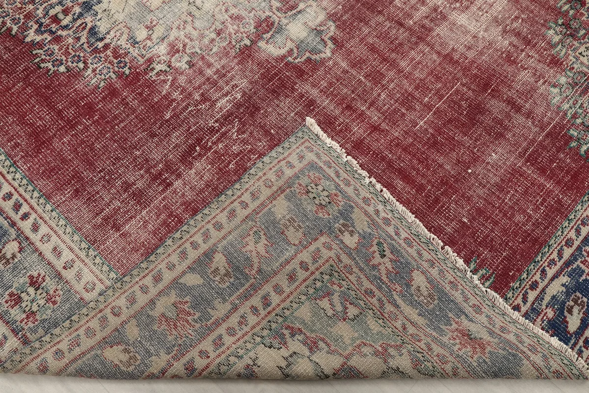 View of the rug's backside, revealing the cotton foundation and hand-knotted construction