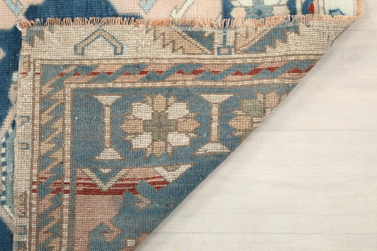 Close-up of the rug's pile and the hand-knotted texture from the reverse side