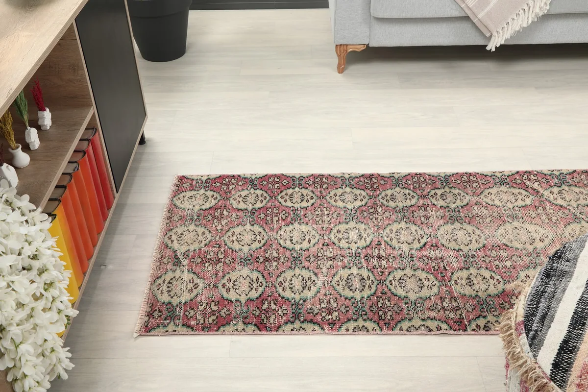 View of the runner rug from a distance in a room, showing its placement relative to furniture.