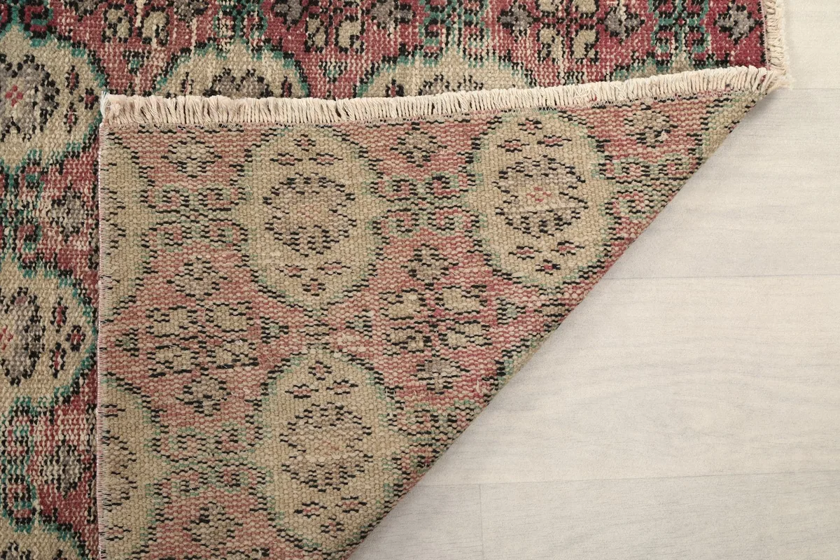 Underside of the runner rug, revealing the woven cotton foundation and the consistency of the hand-knotting.