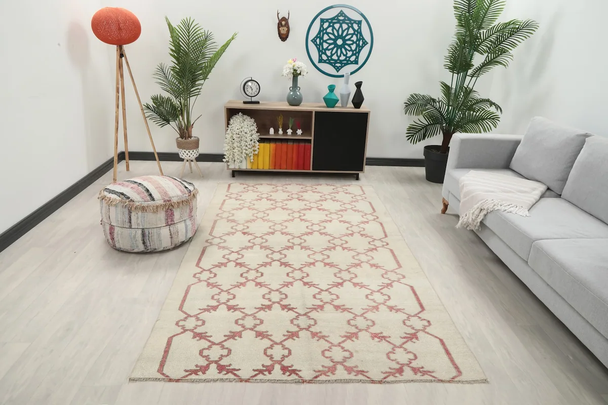 Vintage ivory and rose rug in a living room setting from an angle