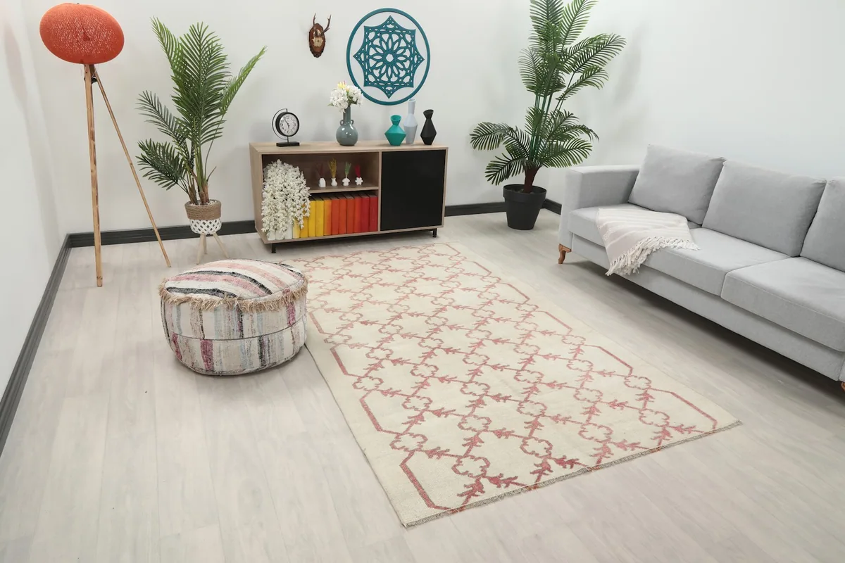 Overhead view of the ivory and rose vintage rug in a living room