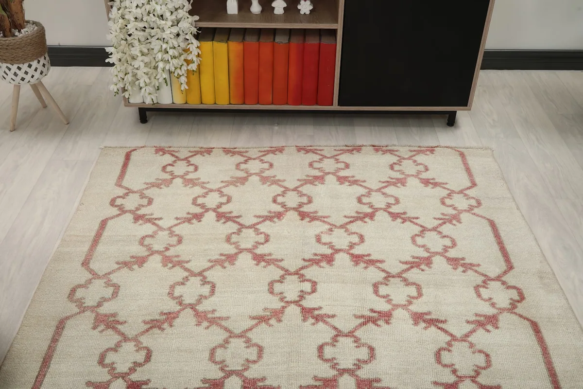 Overhead perspective of the ivory and rose vintage rug in a room