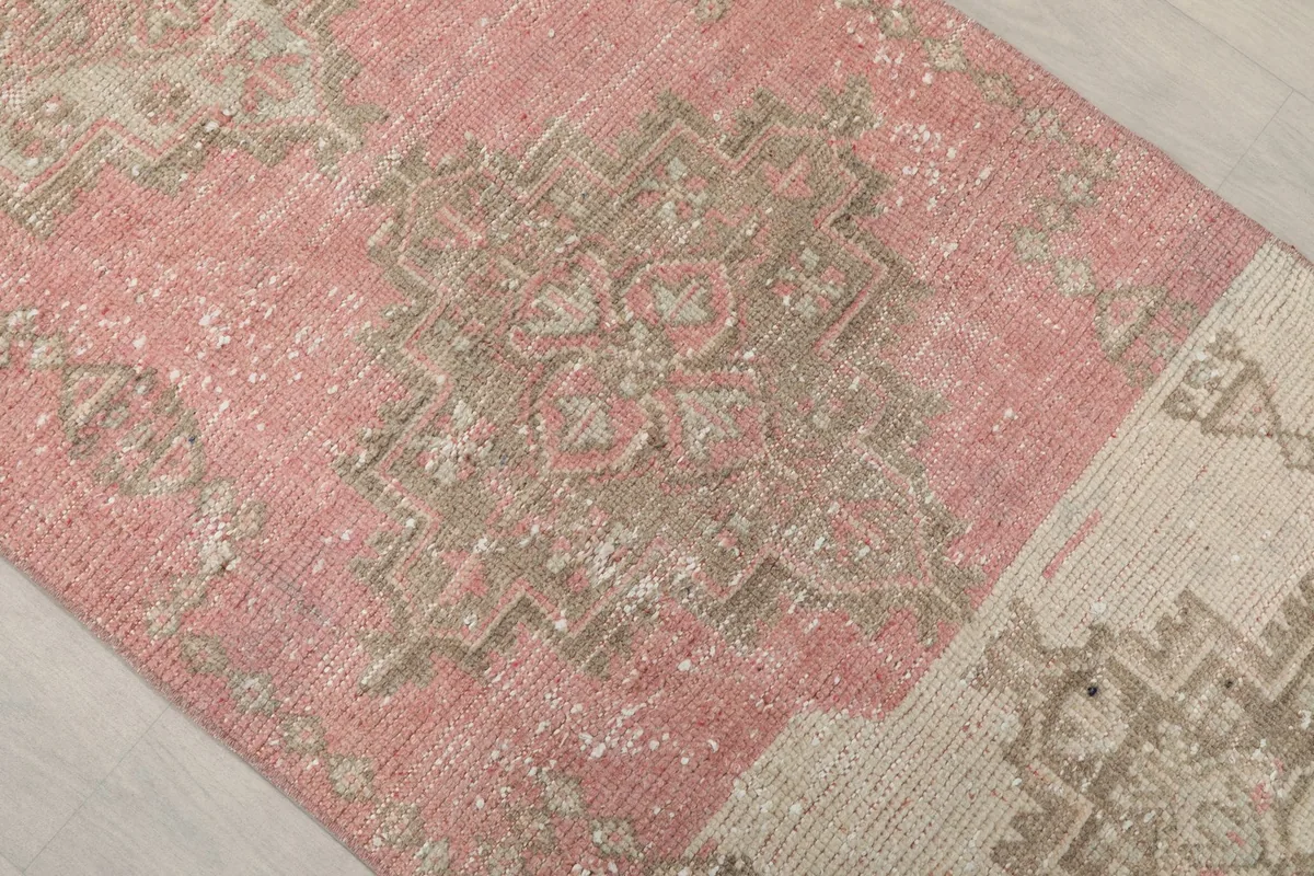 Close-up of the pink section of the runner, revealing geometric patterns and natural color variations
