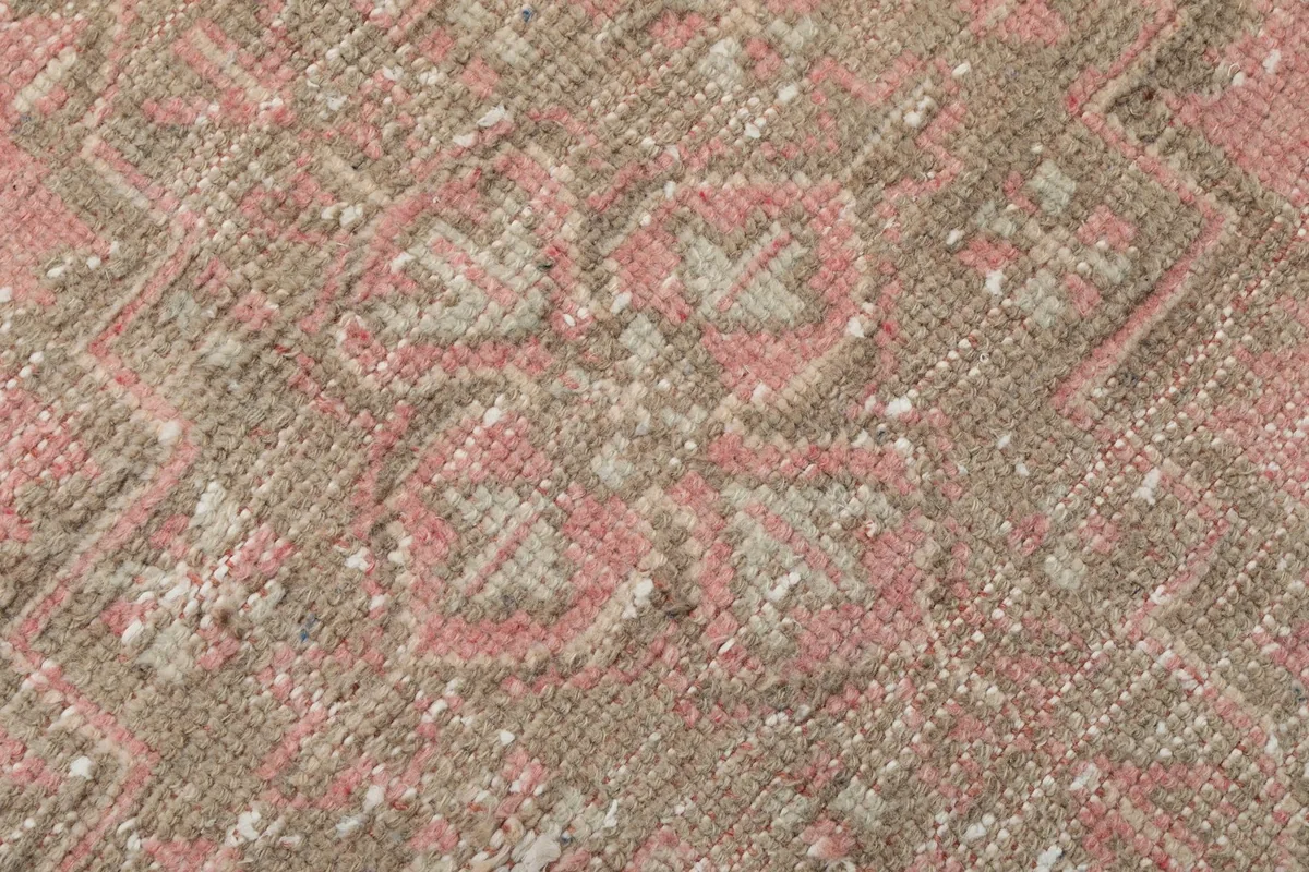 Macro view of the low wool pile, showing the hand-knotted texture and fibers