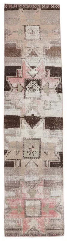 Full overhead view of the pink and brown geometric Anatolian runner rug on a white background