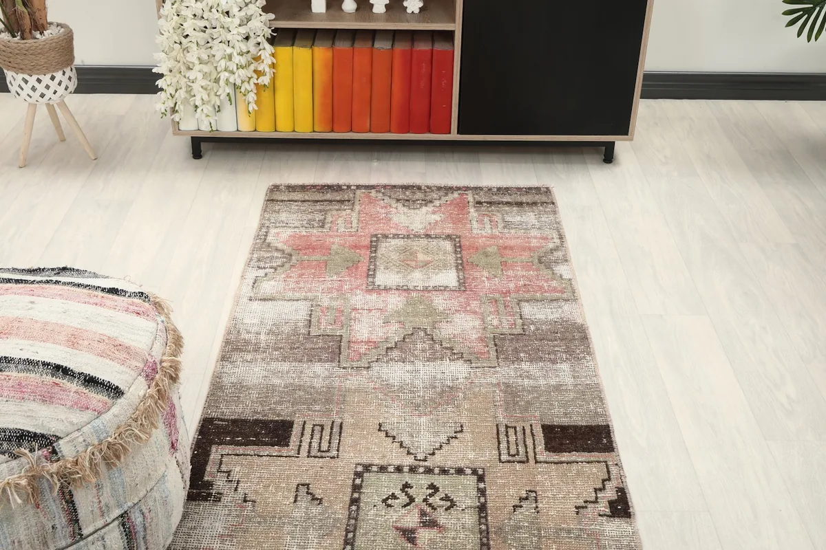 Overhead view of a section of the runner rug in a room, showing its placement near a cabinet