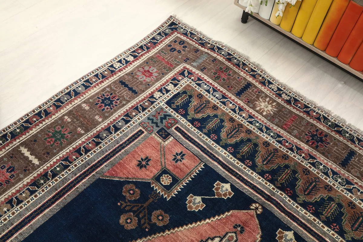 Corner view of the rug, showing the multiple border layers and color variations