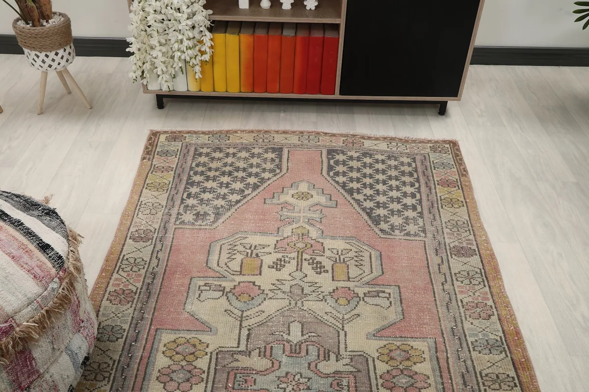 Overhead view of the rose rug in a living room, showing its placement relative to furniture