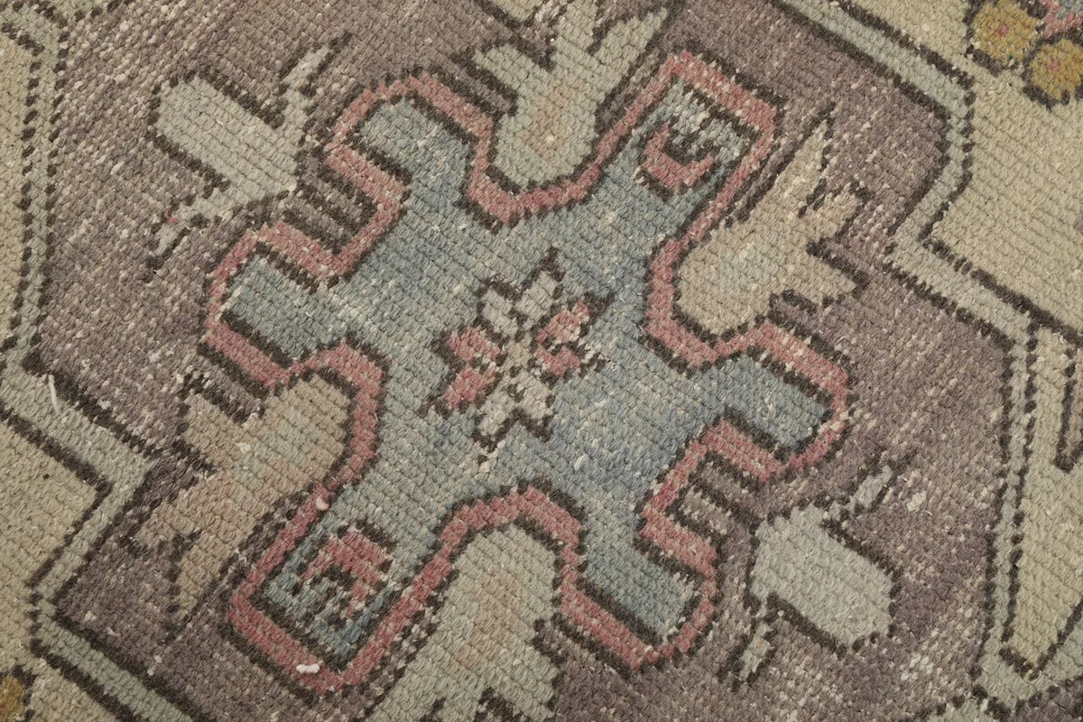 Extreme close-up of the rug's central motif showing individual knots and color variations