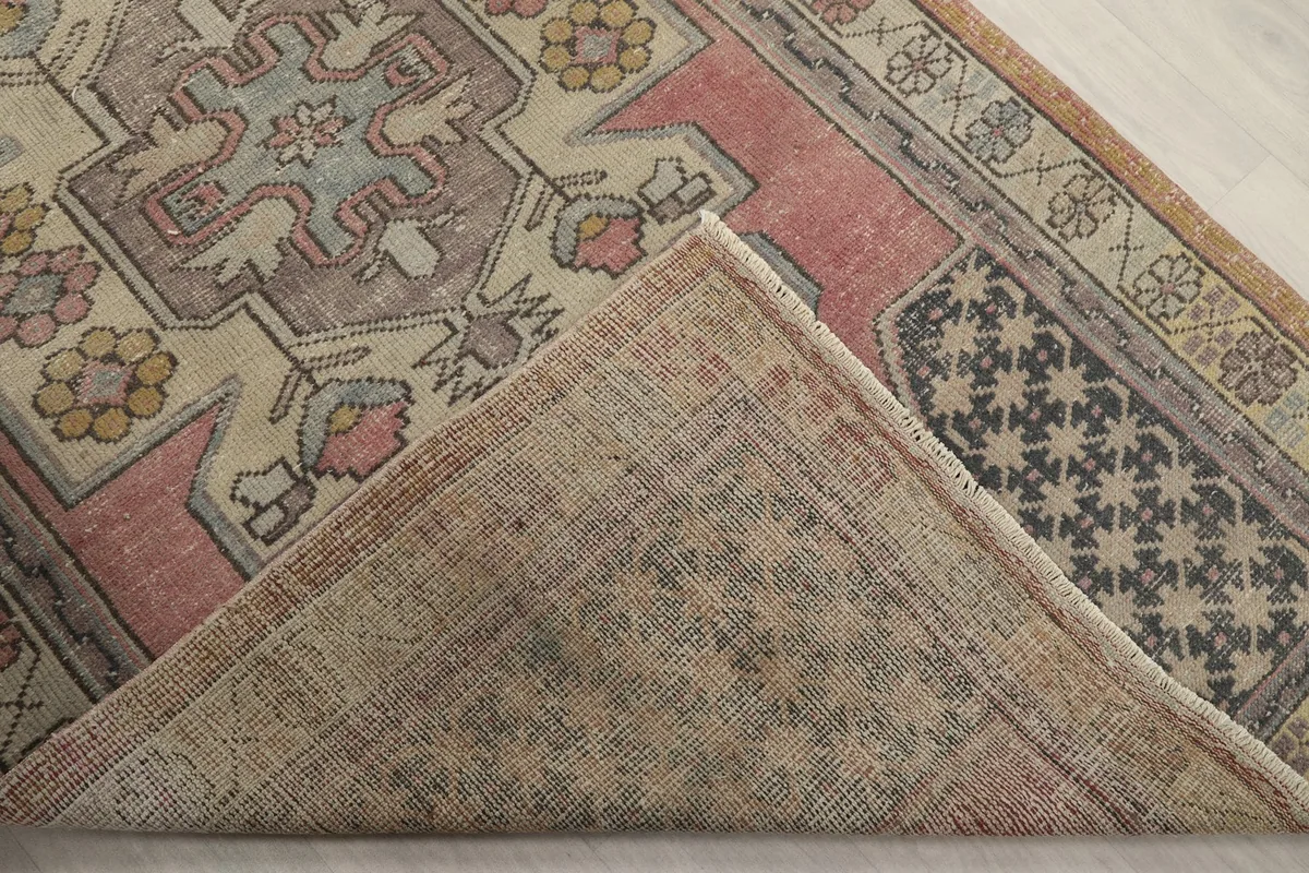 View of the back of the hand-knotted rug, revealing its cotton foundation and craftsmanship