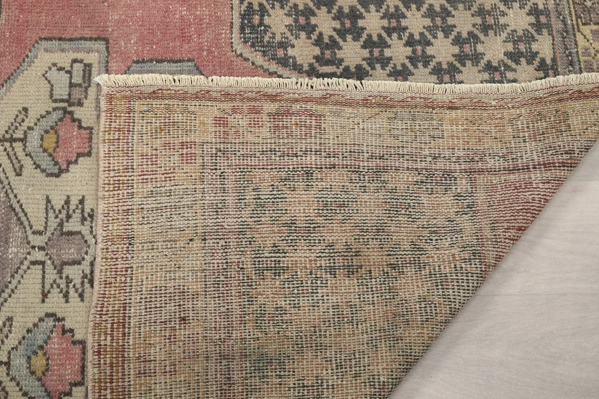 Close-up of the reverse side of the rug, showing the knotting and fringe detail